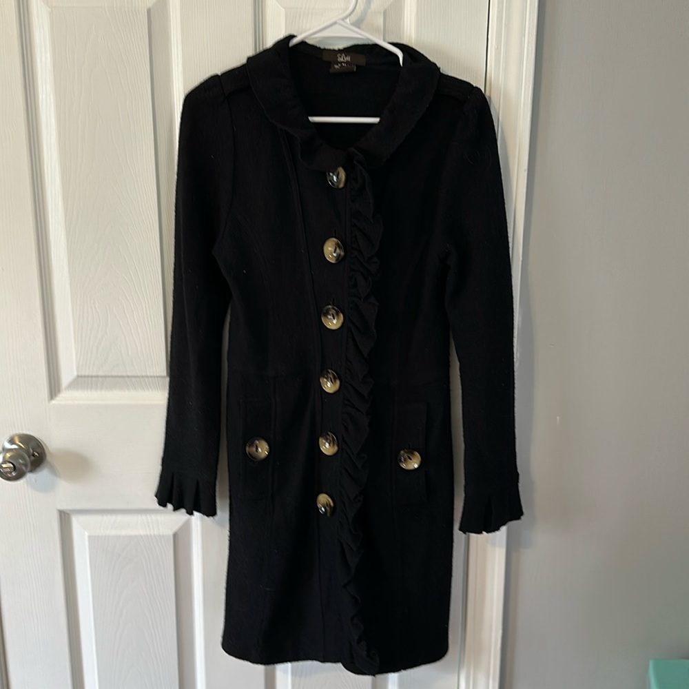Long black all-wool coat with large buttons and frill down the center